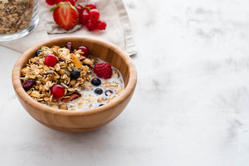 Homemade granola in bowl rustic background. Copy space.