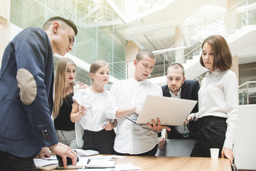 Fototapeta premium Group of business meeting at the table in the modern office ,Team work and diverse hands together joining business relationships with greetings and joint business partnership.