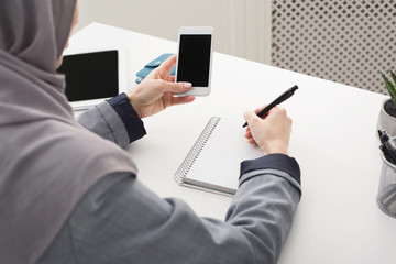 Islam woman working at office, making notes at work table