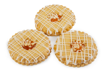 Yellow round shortbread cookies with icing,
cream and nuts.