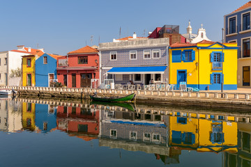 Fototapeta na wymiar Colorful town of Aveiro and reflections in canal waters.