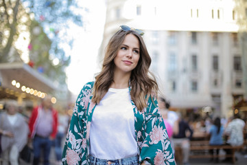 Fototapeta premium Girl walking in the city smiling