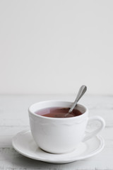 Cup of hibiscus tea on wooden table, copy space. Tea break concept. Healthy herbal drink
