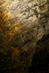 Stone texture background with gold metallic tones