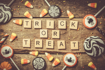 Halloween background - candies and lollipops, straws, wood background