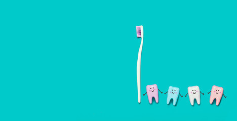 Toothbrush and many teeth on blue background. Minimal