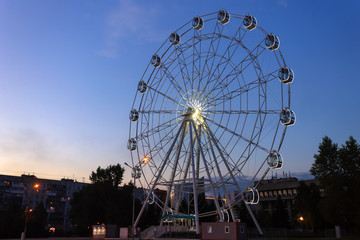 Ferris wheel in the evening in the park