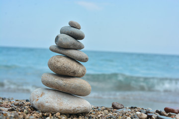 Fototapeta na wymiar Relaxing on the beach, stack of stones.