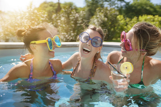 Girl friends in swimming-pool, bachelor party