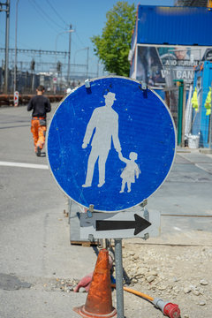 pedestrian sign on street in front of construction site