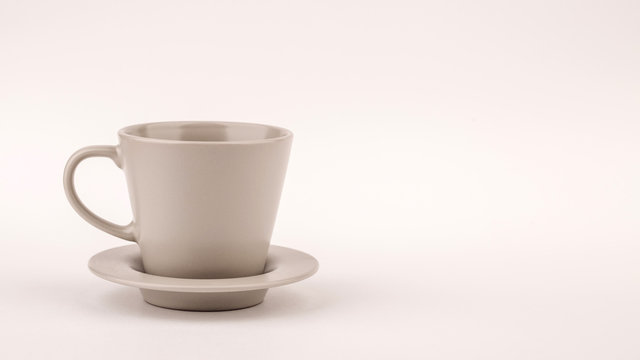 Small white coffee cup on white background