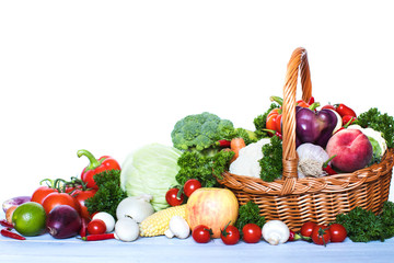 Composition with vegetables and fruits in wicker basket.