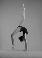 Ballerina in a pose a bridge with a raised leg
