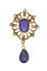 golden vintage brooch with purple stone isolated on white