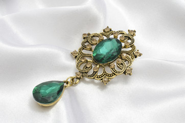 golden vintage brooch with emeralds on silk - 218971971