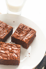 Homemade organic fudge and crispy brownies on white plate