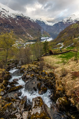 Waterfall flow from hill to Geiranger fjord