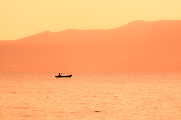 Fototapeta na wymiar kayak sailing at sunset
