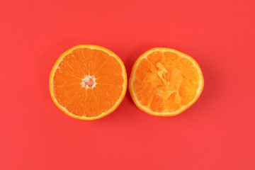 Mandarin Orange Fruit slice half juiced extracted on red background
