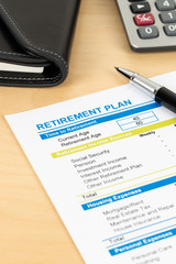 Retirement plan with calculator, document is mock-up