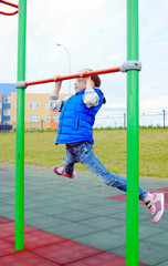 White ten years old girl is engaged in sport on a sports ground outdoor
