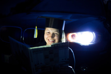 Obraz premium Young woman with student suit sitting near by SUV car headlamp, smilling