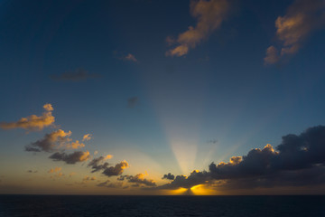 Naklejka na ściany i meble A beautiful sunset on Caribbean see with a unique cloud arrangement.