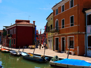 Fototapeta na wymiar The romantic houses painted in brilliant pastel shades on the Island of Burano Italy