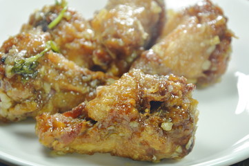 fried chicken leg with sweet sauce on dish