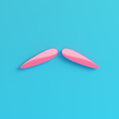 Pink fake mustache on bright blue background in pastel colors