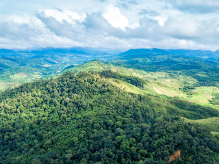 Beautiful mountain scenery rainy weather. Aerial view of rainforest with mist and sunlight in the morning, view of natural high mountain with cloud and sky. Amazing nature landscape.