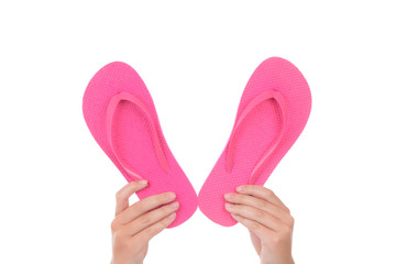 girl holding pink flip flop sandals isolated white background