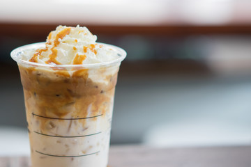 Ice coffee and whipped cream with caramel sauce.