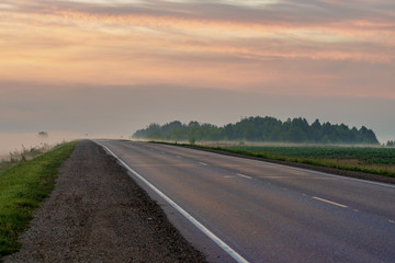 picturesque view of roadway on hill at sunset 
