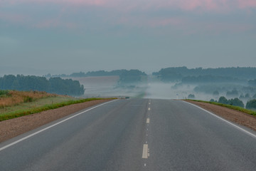 Fototapeta premium picturesque view of roadway on hill at sunset 