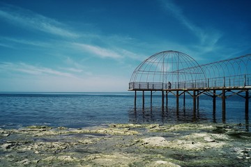 Aktau / Kazakhstan - APR 28 2011: old rusty pier leading to the caspian sea