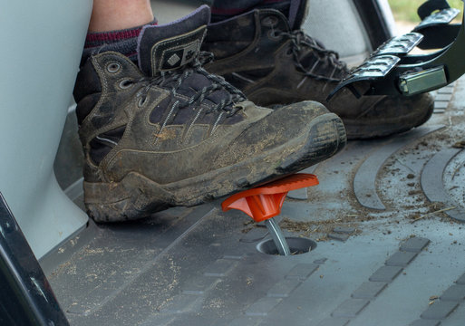 Foot In A Working Boot On A Gas Pedal In A Tractor Or Construction Vehicle