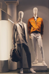 Male mannequin in a shop window. Fashion and sales