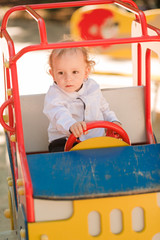 Fototapeta na wymiar Cute baby boy playing on the playground