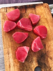 Fresh pink tuna on wooden dinner dishes
