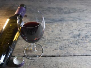 Wine Glass is located on a wooden table.
