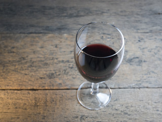 Wine Glass is located on a wooden table.