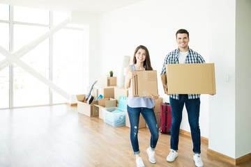 Fototapeta na wymiar Couple With Corrugated Boxes Moving To New House