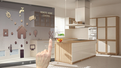Smart home control concept, hand controlling digital interface from mobile app. Blurred background showing modern kitchen, architecture interior design