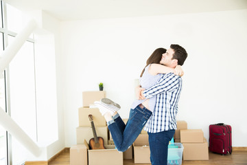 Fototapeta na wymiar Excited Woman Embracing Man In New Apartment