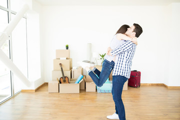 Overjoyed Female Embracing Man While Moving Into New Home