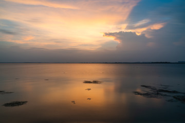 Sunset over the lake, golden light and clouds
