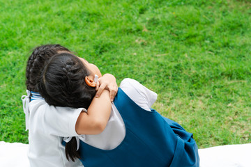 Naklejka premium two little asian girls sisters hugging happy post in school uniform, back to school concept