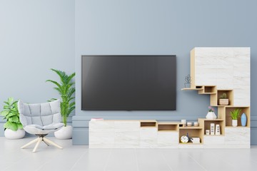 Flat Smart Tv Mockup on cabinet with armchair in modern living room on blue wall background,3d rendering