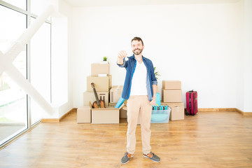 Happy Owner Holding House Keys In New Home